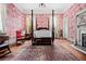 Bedroom with a fireplace, canopy bed, vintage furnishings, and patterned wallpaper at 285 Kennesaw Nw Ave, Marietta, GA 30060