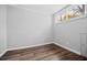 Clean, minimal bedroom with hardwood floors and a large window at 285 Kennesaw Nw Ave, Marietta, GA 30060