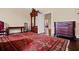 Bedroom with hardwood floors, decorative rug, vintage furniture, and a view to an adjoining room at 285 Kennesaw Nw Ave, Marietta, GA 30060