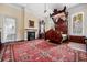 Spacious bedroom featuring a four-poster bed, fireplace, and a bright bathroom en suite at 285 Kennesaw Nw Ave, Marietta, GA 30060