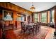 Sophisticated dining room boasting dark wood paneling, mural wallpaper, and a large formal table at 285 Kennesaw Nw Ave, Marietta, GA 30060
