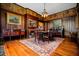 Formal dining room with wood paneling, a decorative fireplace, and elegant antique furnishings at 285 Kennesaw Nw Ave, Marietta, GA 30060