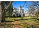 A beautiful historic home with mature trees, a brick walkway, and a well-maintained lawn at 285 Kennesaw Nw Ave, Marietta, GA 30060
