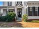 Charming front entrance with brick steps and lush landscaping leading to a classic double-door entryway at 285 Kennesaw Nw Ave, Marietta, GA 30060