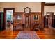Hallway with wood paneling, hardwood floors, antique furniture, and portraits adorning the walls at 285 Kennesaw Nw Ave, Marietta, GA 30060
