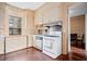 Quaint kitchen with vintage white cabinets, gas range, and a window overlooking the greenery at 285 Kennesaw Nw Ave, Marietta, GA 30060