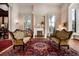 Elegant living room featuring a decorative fireplace, large windows, and stylish patterned rug at 285 Kennesaw Nw Ave, Marietta, GA 30060