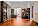 Large room with hardwood floors, multiple bookshelves, and a rocking chair at 285 Kennesaw Nw Ave, Marietta, GA 30060