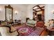 Living room with an ornate mirror, hardwood floors, decorative wallpaper, and vintage furnishings at 285 Kennesaw Nw Ave, Marietta, GA 30060