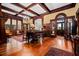 Elegant living room with hardwood floors, coffered ceilings, large windows, and a vintage piano at 285 Kennesaw Nw Ave, Marietta, GA 30060