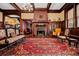 Grand living room showcasing a brick fireplace, hardwood floors, built-in shelves, and classic furnishings at 285 Kennesaw Nw Ave, Marietta, GA 30060