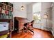 Cozy office space featuring a roll-top desk, a window, and a bookshelf filled with books at 285 Kennesaw Nw Ave, Marietta, GA 30060