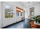 Bright sunroom with shiplap walls, a ceiling fan, black stained wood flooring and lots of natural light from the large windows at 285 Kennesaw Nw Ave, Marietta, GA 30060