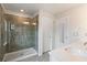Modern bathroom featuring a glass-enclosed shower with tiled walls and a white sink at 3420 Reagan Way, Lawrenceville, GA 30044