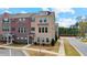 Two-story townhome featuring a brick facade, well-maintained landscaping, and convenient parking spaces at 3420 Reagan Way, Lawrenceville, GA 30044