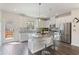 Open kitchen with stainless steel appliances, granite island, and bar stool seating at 3420 Reagan Way, Lawrenceville, GA 30044
