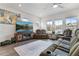 Comfortable living room featuring a large TV, plush seating, and ample natural light at 3420 Reagan Way, Lawrenceville, GA 30044