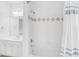 Bright bathroom with shower/tub combo, vanity with sink and classic tile accents at 4428 Wilkerson Manor Se Dr # 6, Smyrna, GA 30080