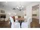 Dining area with chandelier lighting, table, and natural light with views to living room and fireplace at 4428 Wilkerson Manor Se Dr # 6, Smyrna, GA 30080