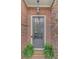 A welcoming brick entryway featuring a stylish front door with glass panels and decorative ferns at 4428 Wilkerson Manor Se Dr # 6, Smyrna, GA 30080