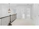 Upstairs hallway with doors, decorative chandelier, and neutral carpet at 4428 Wilkerson Manor Se Dr # 6, Smyrna, GA 30080