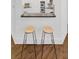 Kitchen bar with sleek stools and a view into a modern, well-equipped kitchen at 4428 Wilkerson Manor Se Dr # 6, Smyrna, GA 30080
