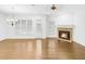 Open living room featuring hardwood floors, a stone fireplace, and plenty of natural light at 4428 Wilkerson Manor Se Dr # 6, Smyrna, GA 30080