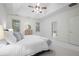 Bright main bedroom with tray ceiling, ceiling fan, ensuite bathroom, and natural light at 4428 Wilkerson Manor Se Dr # 6, Smyrna, GA 30080