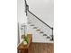 Elegant staircase with dark wood treads, black iron railing, and hardwood floors at 4428 Wilkerson Manor Se Dr # 6, Smyrna, GA 30080