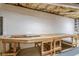 Basement with a large work table and exposed insulation, perfect for DIY projects and storage solutions at 452 Hightower Ridge Rd, Covington, GA 30014
