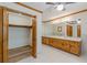 Bathroom with wood cabinets, double vanity, wood trim, and a walk-in closet at 452 Hightower Ridge Rd, Covington, GA 30014