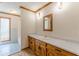 Bathroom with wood vanity, marble countertop, modern fixtures, and plank flooring at 452 Hightower Ridge Rd, Covington, GA 30014