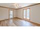 Bedroom with wood floors and a window that overlooks a wooded area and a door to a balcony at 452 Hightower Ridge Rd, Covington, GA 30014