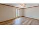 A bright bedroom features wood floors, a ceiling fan, and a large window with a natural view at 452 Hightower Ridge Rd, Covington, GA 30014