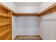 Walk-in closet with custom wood shelving and ample storage space at 452 Hightower Ridge Rd, Covington, GA 30014
