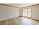 Dining room with plank flooring, modern chandelier, and large window at 452 Hightower Ridge Rd, Covington, GA 30014