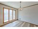 Bright dining room with hardwood floors, chandelier, and large windows at 452 Hightower Ridge Rd, Covington, GA 30014