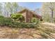 Brick home with a covered patio, upper level balconies, spiral staircase, and manicured landscaping at 452 Hightower Ridge Rd, Covington, GA 30014
