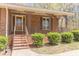 Inviting front porch with decorative metal railings, a ceiling fan, and well-manicured bushes at 452 Hightower Ridge Rd, Covington, GA 30014