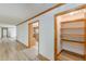 Hallway with wood trim and plank flooring leading to a pantry and kitchen at 452 Hightower Ridge Rd, Covington, GA 30014