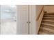 Hallway featuring stairs and an open door that leads into a living area at 452 Hightower Ridge Rd, Covington, GA 30014