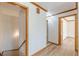 Hallway with wood floors, wood trim and doors with access to stairs, bedrooms, and bathrooms at 452 Hightower Ridge Rd, Covington, GA 30014