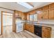 Bright kitchen featuring wood cabinets, granite countertops, stainless steel sink, and modern appliances at 452 Hightower Ridge Rd, Covington, GA 30014