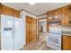 Kitchen with wood cabinets, granite countertops, white refrigerator, and view of pantry storage space at 452 Hightower Ridge Rd, Covington, GA 30014
