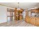 Open kitchen with natural wood cabinets, an adjacent workspace, and hardwood floors at 452 Hightower Ridge Rd, Covington, GA 30014