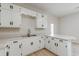 Bright kitchen featuring white cabinetry and light countertops and wood-look flooring at 452 Hightower Ridge Rd, Covington, GA 30014