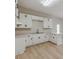 Well-lit kitchen featuring white cabinets and a peninsula island at 452 Hightower Ridge Rd, Covington, GA 30014