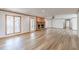 Spacious living room with hardwood floors, a brick fireplace, and multiple windows at 452 Hightower Ridge Rd, Covington, GA 30014