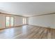Living room with wood floors, wood trim and windows with a wooded view at 452 Hightower Ridge Rd, Covington, GA 30014