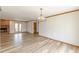 Open-concept living room featuring plank flooring, brick fireplace, and access to other rooms at 452 Hightower Ridge Rd, Covington, GA 30014